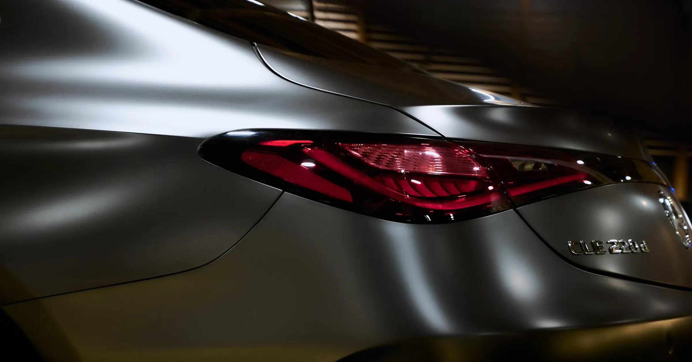 Feu arrière LED d’une Mercedes-Benz CLE 220 d gris mat en clair-obscur, photographe automobile à La Roche-sur-Foron