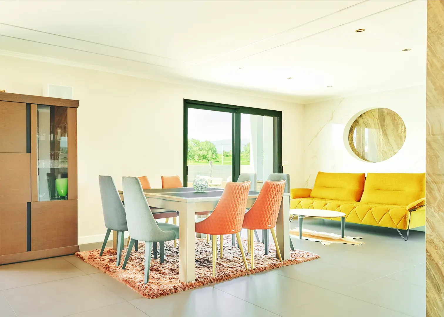 Séjour lumineux avec salle à manger et canapé jaune, photographie immobilière haut de gamme en Suisse romande